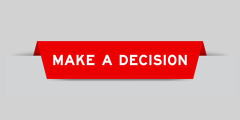 Red color inserted label with word make a decision on gray background