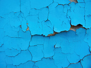 Old cracked wall background, dirty grunge texture. Paint peeling plaster walls. the cement walls are broken blue paint