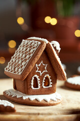 Gingerbread house with Christmas lights in the background