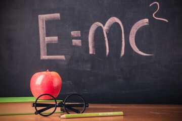 Equation E=mc2 handwritten on blackboard