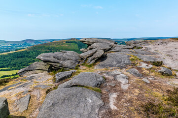 Fototapeta na wymiar A view of dramatic rock outcrops on the top of the Bamford Edge escarpment in summertime