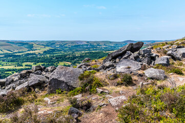 Fototapeta na wymiar A view of rock outcrops on the top of the Bamford Edge escarpment in summertime