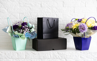 black gift box on bouquet of flowers