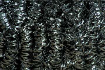 steel tangled spiral metal fibers background, macro photography close-up