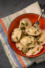 Dumplings with cabbage, bacon and green onions