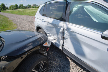 Damaged in heavy car accident vehicles after collision on city street crash site. Road safety and...