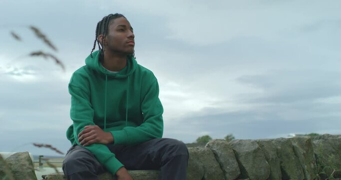 MS Teenage boy (16-17) sitting outdoors