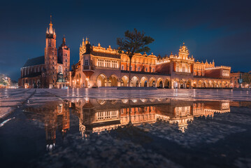 The main square in Krakow with a view of the cloth hall, St. Mary's Basilica in a natural mirror....