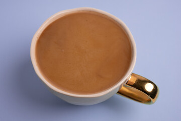 Top view to white cup with delicious coffee on purple background. Greeting card. Post card. Place for your text.