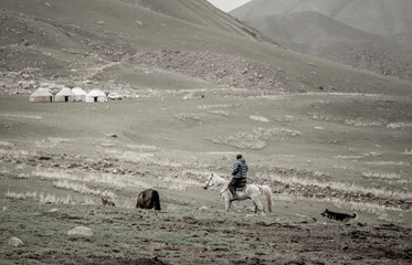 A nomad rides into a yurt camp in the mountains of Kyrgyzstan.