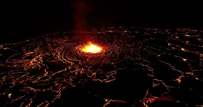  Magma erupting from volcano crater under dark sky.