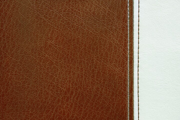 Fototapeta premium Natural, artificial brown and white leather texture background with vertical decorative seam. Material for sport items, clothes, furnitre and interior design. ecological friendly leatherette.