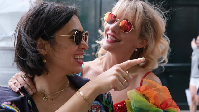 CU Smiling female couple talking in street