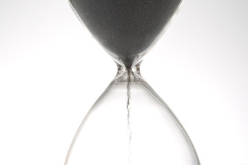 Hourglass on a light background. Time is money. Business solutions in time.