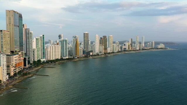 Aerial view of Cartagena shows skyscrapers by Caribbean sea.