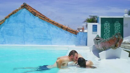 Lovely couple in swimming pool on their vacation in cartagena. - Powered by Adobe