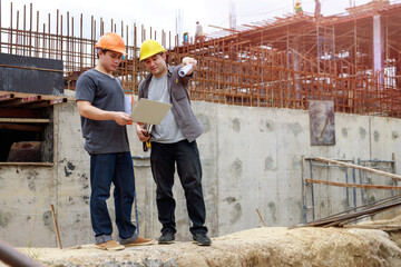 Construction concept of Engineer and Architect working at Construction Site with blue print