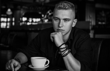 Young European man with a sad philosophical mood. The concept of life, problems and depression. Crisis of young age