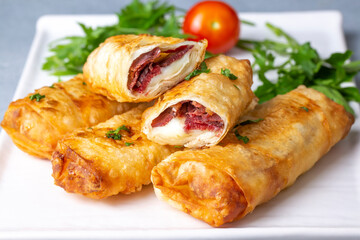 Turkish Pacanga Boregi with pastirma (pastrami) and cheddar (melted) cheese. - Pastirmali Borek