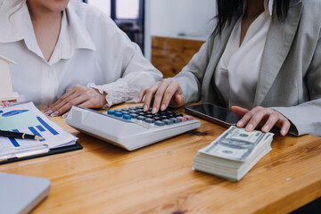Fototapeta premium Businesswoman or accountant working Financial investment on calculator, calculate, analyze business and marketing growth on financial document data graph, Accounting, Economic, commercial concept.