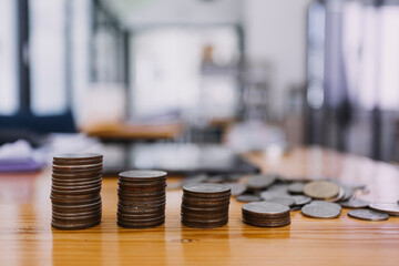 businessman hand putting coin in piggy bank. Saving money concept, business finance and investment.