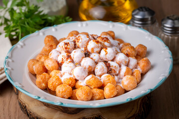 Traditional Turkish food, Mirik Kofte made from bulgur, onion and eggs with yoghurt