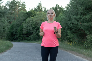 a young girl runs in the woods Doing sports Healthy lifestyle