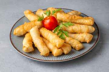 Fried pastry wrapped in cheese in phyllo. Pie in the form of a roll. Turkish name; Kalem borek - sigara boregi