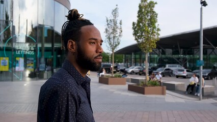MS TS Stylish man with bag walking in city / London, UK