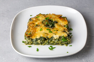 Baked Spinach with cheese delicious Italian food cuisine. Spinach gratin.