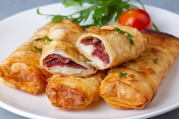 Turkish Pacanga Boregi with pastirma (pastrami) and cheddar (melted) cheese. - Pastirmali Borek