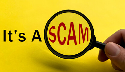 It's a scam text on yellow cover with magnifying glass. Scamming and fraud concept.