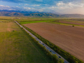 Fantastic landscape, aerial photography from a plowed field with mountains in the background. Issyk fields are not far from Almaty
