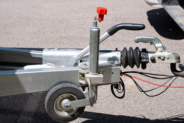 Trailer attachment system. Trailer lock on the background of asphalt.
