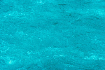 Turquoise water of mountain lake as background. Blue river with ripples and reflection