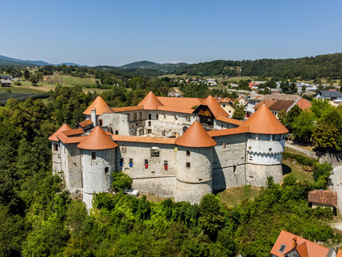 Aerial drone view of Medieval castle of Zuzemberk or Seisenburg or Sosenberch, positioned on terrace above the Krka River Canyon, Central Slovenia.