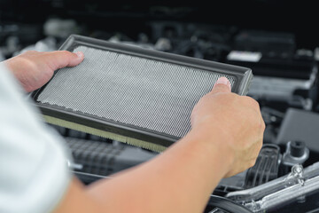The technician holds Air flow filter of car engine to check dust on filter the service period is over to change spare parts according to the specified service life,car service concept - obrazy, fototapety, plakaty