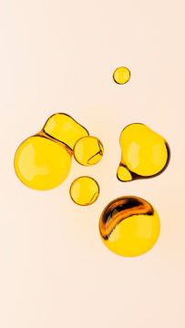 3d rendering illustration of oil drops on isolated light yellow background. Transparent realistic liquid shapes. Beauty industry concept