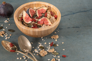 Granola for healthy breakfast. Bowl with granola , milk , fresh fig and dried berries