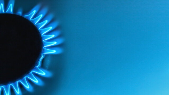 blue natural gas flame with space for text on light blue background