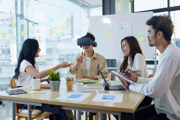 Group of young entrepreneur in Asia used virtual reality glasses during the conference to test the performance of virtual reality headsets and exchange ideas share new knowledge approaches.