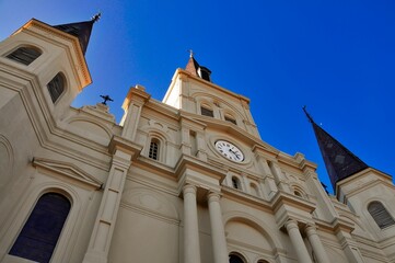 Low-angle view of St. Louis Catherdral in New Orleans, Louisiana, with a blue sky in the background