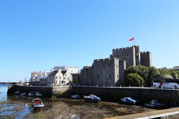 Fototapeta premium A view of Rushen Castle from across the harbour in Castletown on the southern coast of the Isle of Man.