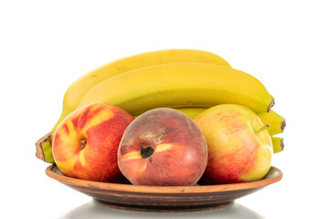 One bunch of bananas, apple, peach and nectarine on a ceramic plate, close-up, isolated on a white background.