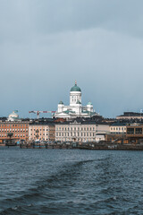 Facade of the Helsinki Cathedral against a blue cloudy sky