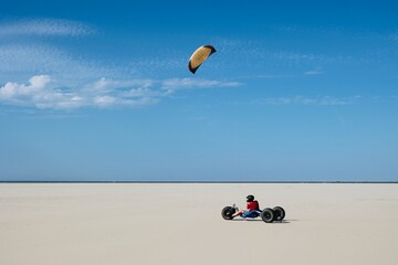 Kite Buggy on the beach of Texel Island, The Netherlands.  - obrazy, fototapety, plakaty