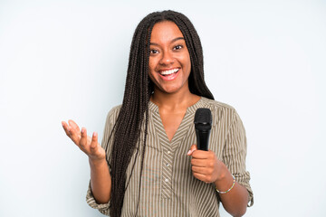 black pretty woman feeling happy, surprised realizing a solution or idea. singer with a microphone