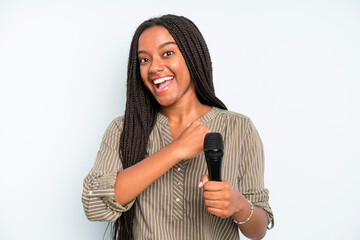 black pretty woman feeling happy and facing a challenge or celebrating. singer with a microphone