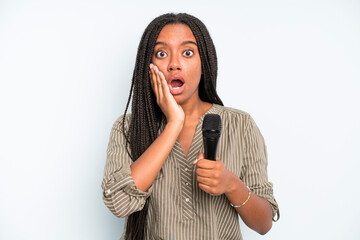 black pretty woman feeling shocked and scared. singer with a microphone