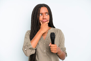 black pretty woman thinking, feeling doubtful and confused. singer with a microphone